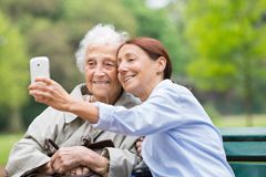 Senior and caregiver with cellphone